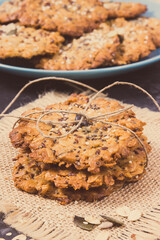 Fresh baked oatmeal cookies on jute canvas. Delicious crunchy dessert