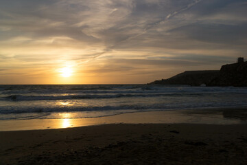 Stunning sunset over sea in Golden Bay Malta.