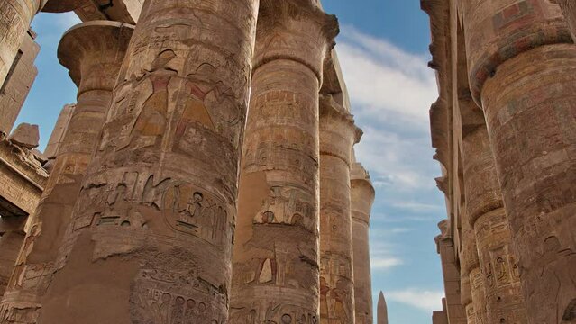 Large stone pillars with carvings and hieroglyphs in the Egyptian Karnak Temple, UNESCO World Heritage Site, in Luxor, Egypt