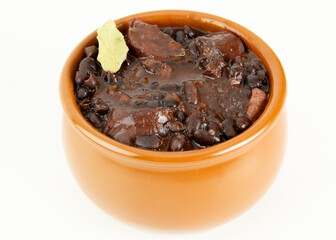 Brazilian Feijoada Food black bean stew with bacon and pork sausage ceramic bowl white background