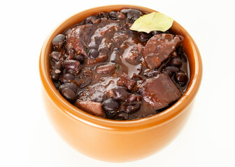 Brazilian Feijoada Food black bean stew with bacon and pork sausage ceramic bowl white background