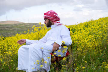 Wellness in nature for arab male between yellow flowers