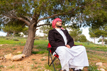 Wellness in nature for arab male between yellow flowers