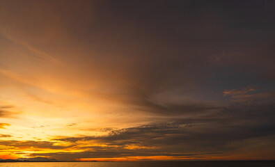 Sunset sky clouds over sea in the evening on twilight with blue, purple, pink and orange sunlight, Horizon sea sky landscape backgrounds in summer
