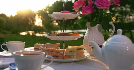 Traditional English afternoon tea on warm summer afternoon. - Powered by Adobe