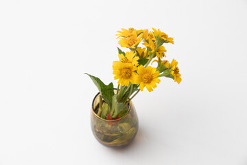 Beautiful yellow flowers in a brown vase home decoration or office with flowers in a vase. Star Daisy or Butter Daisy flower in vase.