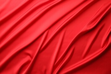 Obraz premium Crumpled red silk fabric as background, top view