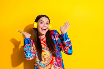 Photo portrait of lovely young lady headphones enjoy music dressed stylish colorful garment isolated on yellow color background