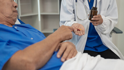 Senior Asian male patient visits the doctor for his annual checkup. Caregivers in caring for the elderly provide assistance on the bed Hospitals and Medicine and Health Care and Life Insurance