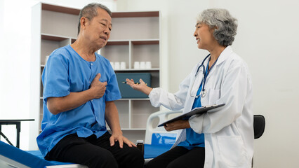 Senior Asian male patient visits the doctor for his annual checkup. Caregivers in caring for the elderly provide assistance on the bed Hospitals and Medicine and Health Care and Life Insurance