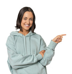 Young Caucasian woman with short hair smiling cheerfully pointing with forefinger away.