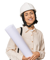 Young Caucasian female architect with blueprints in studio