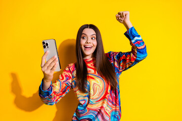 Photo portrait of attractive teen woman hold device winning dressed stylish colorful clothes...