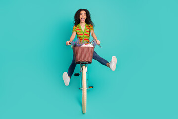 Full body photo of pretty young girl ride bicycle playful wear trendy striped outfit isolated on...