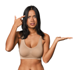 Young Filipino woman in light wear  holding and showing a product on hand.