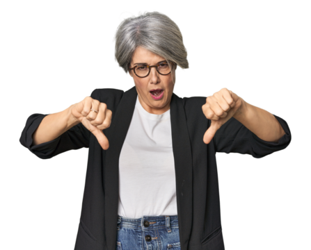 Caucasian mid-age female in business suit showing thumb down and expressing dislike.