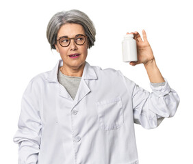 Middle-aged Caucasian female pharmacist with pills