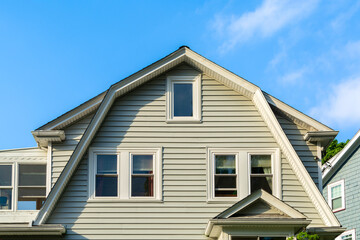 Classic American house facade with gable roof against blue sky, Brighton, Massachusetts, USA