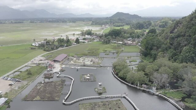 Establish aerial view of the water tourism in Banto Royo, Agam Regency, West Sumatra. d-log raw stock video