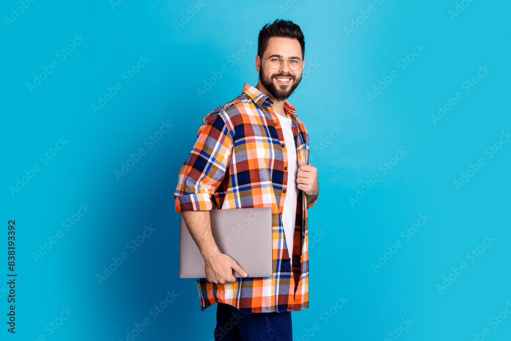 Poster Photo of nice young man hold laptop wear shirt isolated on blue color background