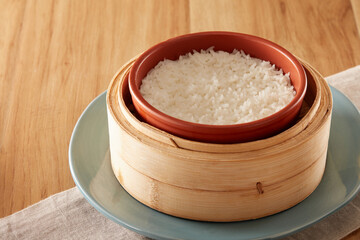 A bowl of steamed rice in a steamer