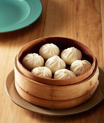 7 xiao long bao in a steamer basket