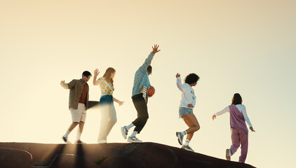 Happy students enjoying friendship and moving outdoors during sunset