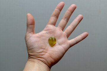 Pill on human hand medical concept