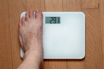 A person measuring weight on a scale