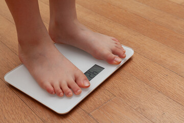 A person measuring weight on a scale