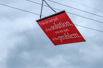 "If you are not part of the solution, you are part of the problem" Sign Hangs over Residential Street in New Orleans, LA, USA