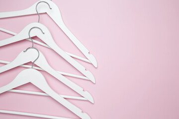 Creative flat lay hangers pink background. Sale discount store promo shopping concept. Top view. Copy space