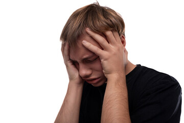 Fototapeta premium Worried young man with blond hair in a black T-shirt thinks about problems and holds his head