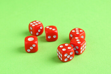 Many red game dices on green background