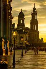 Historic Dresden Street at Sunset with Glowing Lanterns and Silhouetted Towers