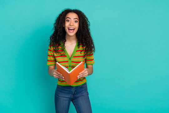 Photo portrait of pretty young girl read book excited wear trendy striped outfit isolated on aquamarine color background