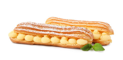 Delicious eclairs filled with cream and mint isolated on white