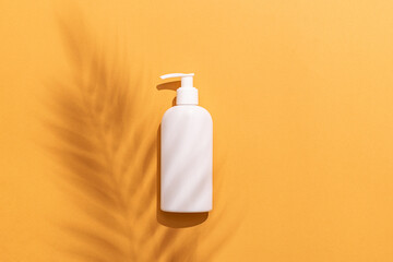 Summer sun protection cosmetic concept. White unbranded container with SPF cream, balm or lotion on...