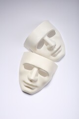 Theater arts. Two masks on white background, top view