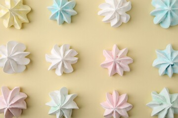Delicious meringue cookies on beige background, flat lay