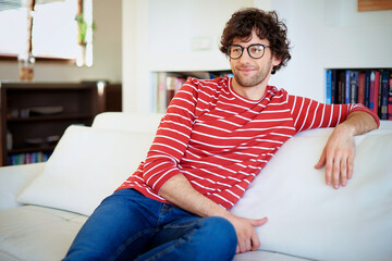 Handsome young man relaxing on the sofa at home