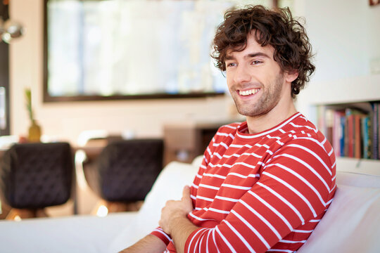 Handsome young man relaxing on the sofa at home