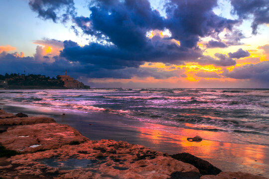 Dramatic sunset over beach, Old Jaffa, Tel Aviv, Israel