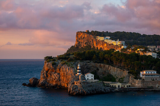 Sa Creu lighthouse on coastal cliffs at sunset, Port de Soller, Majorca, Balearic Islands, Spain