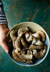 Raw shrimps on the dark rustic background