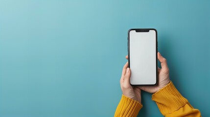 A minimalist image showing hands holding a smartphone with a blank screen against a blue background. This clean and simple composition highlights modern technology and potential customization