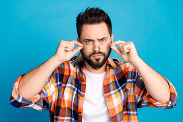 Photo of nice young man touch eyeglasses think wear shirt isolated on blue color background