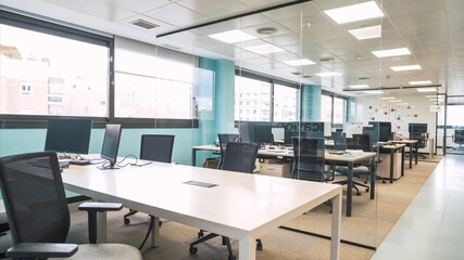 Interior of bright creative coworking workspace with computer desks