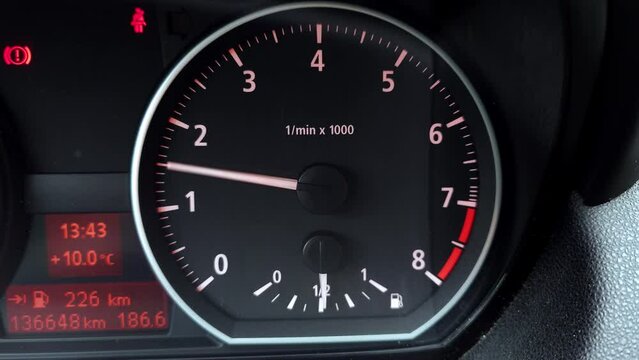 Car rev counter gauge and needle. Revving the engine up to red line limiter. Close up, real time, sound, no people