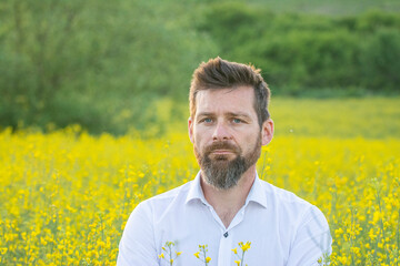 man in beautiful yellow rapeseed field